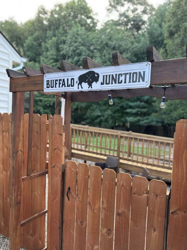 Buffalo Junction sign mounted on the pergola gate