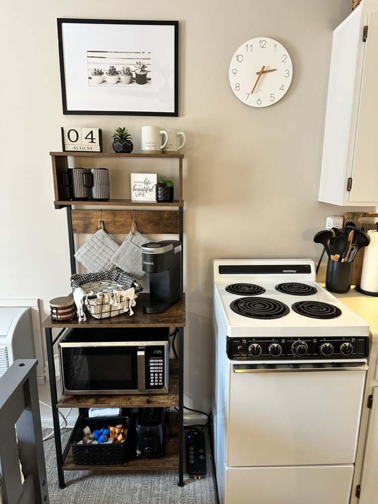 Coffee bar shelf with Keurig next to the electric stove