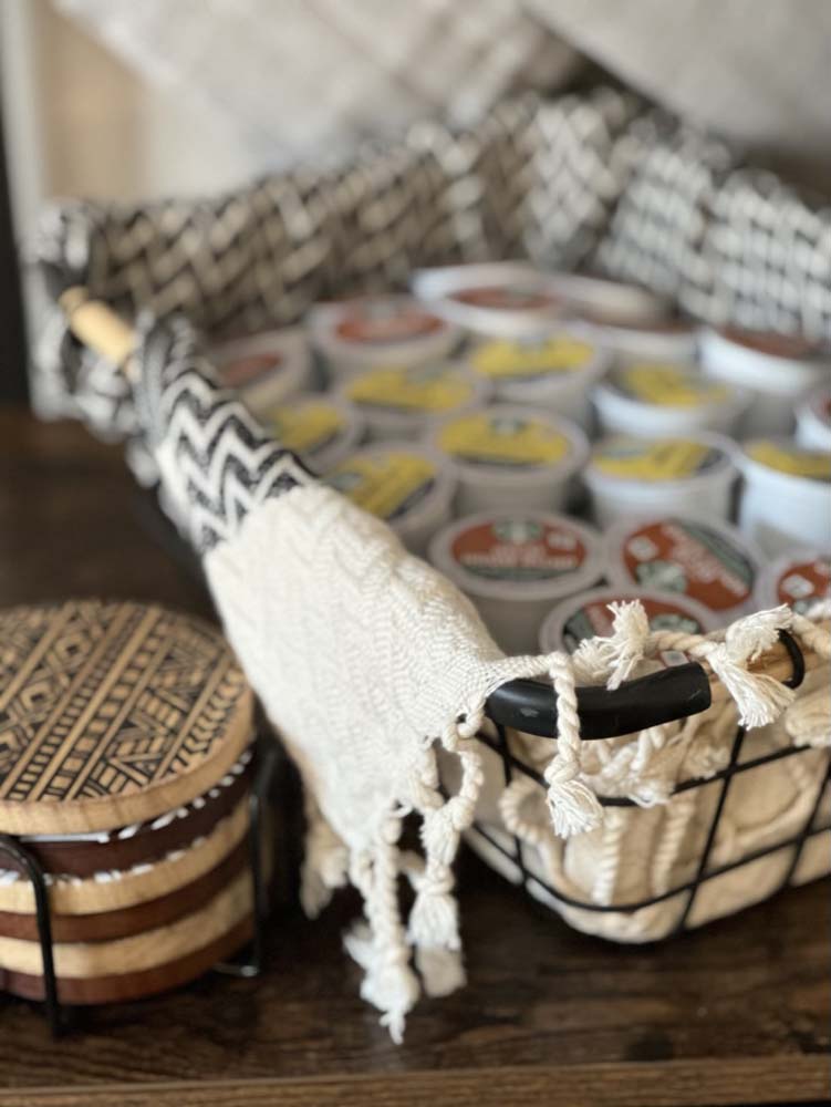 Wire basket of K-cups with woven towel and coasters