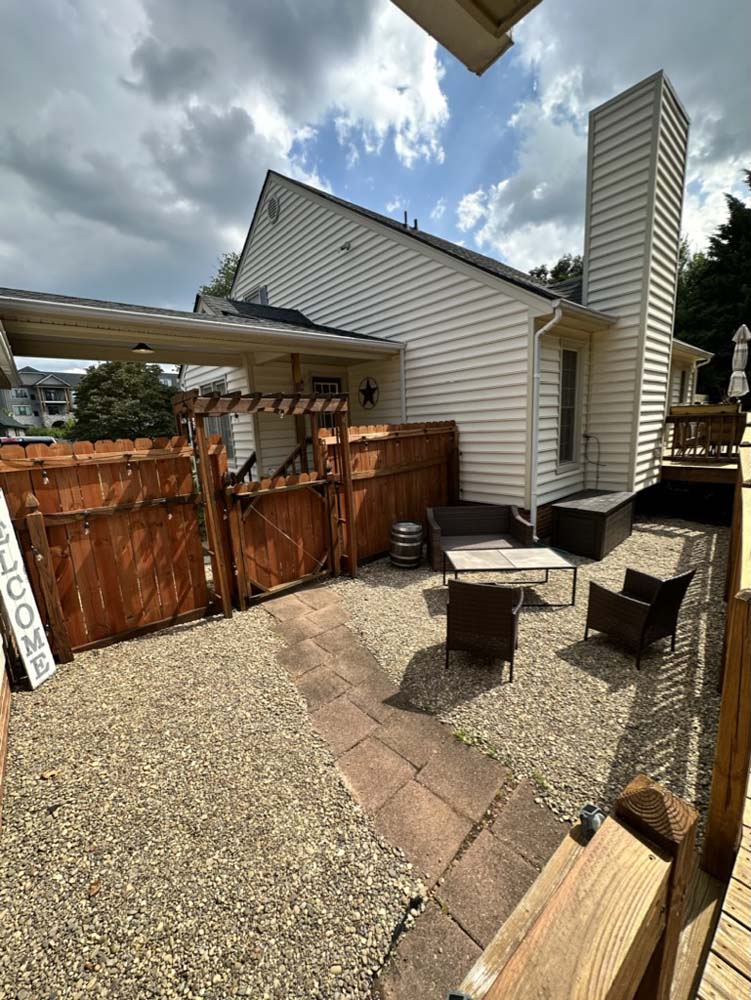 Private gravel courtyard with patio seating in daylight