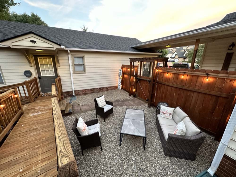 Courtyard at dusk with private entry, seating, and string lights