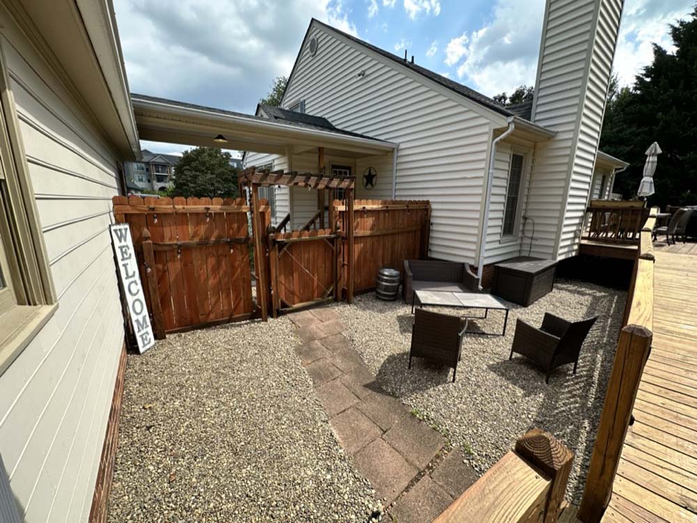 Private courtyard in daylight with welcome sign and pergola