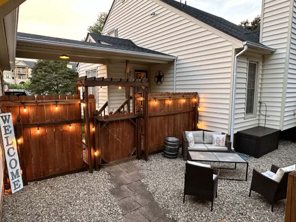 Courtyard at dusk with string lights and welcome sign