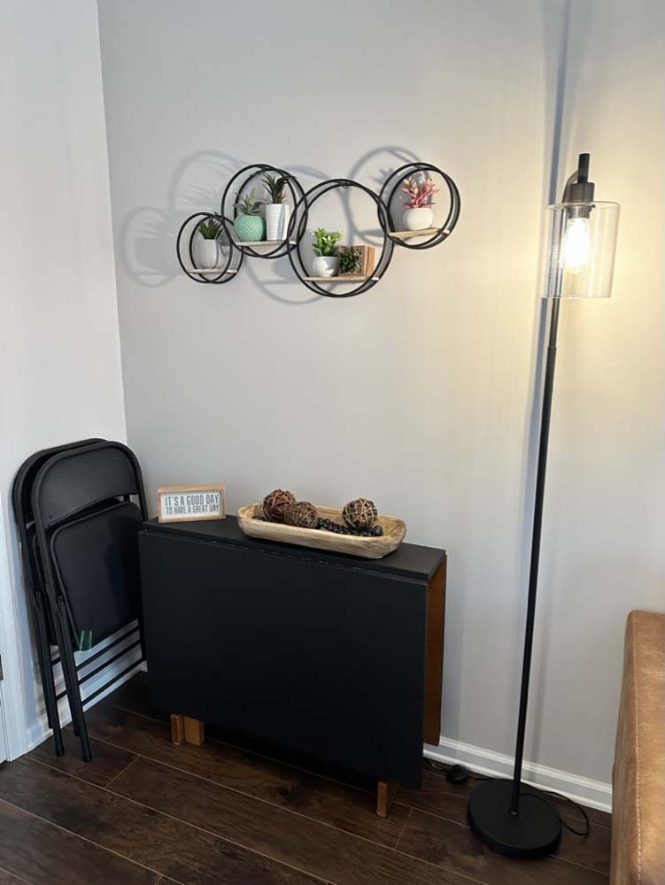 Folding dining table with floor lamp and wall planter shelf