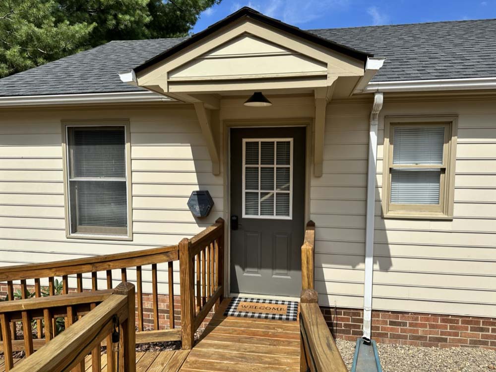 Private front entry with welcome mat and covered porch
