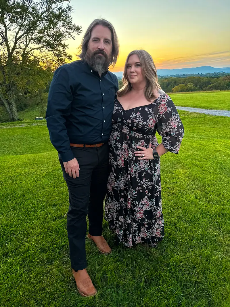 Mike and Kate, the hosts of Buffalo Junction, at sunset by the water