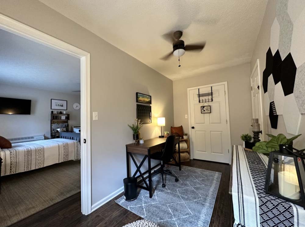 Office room with desk and open view into the bedroom