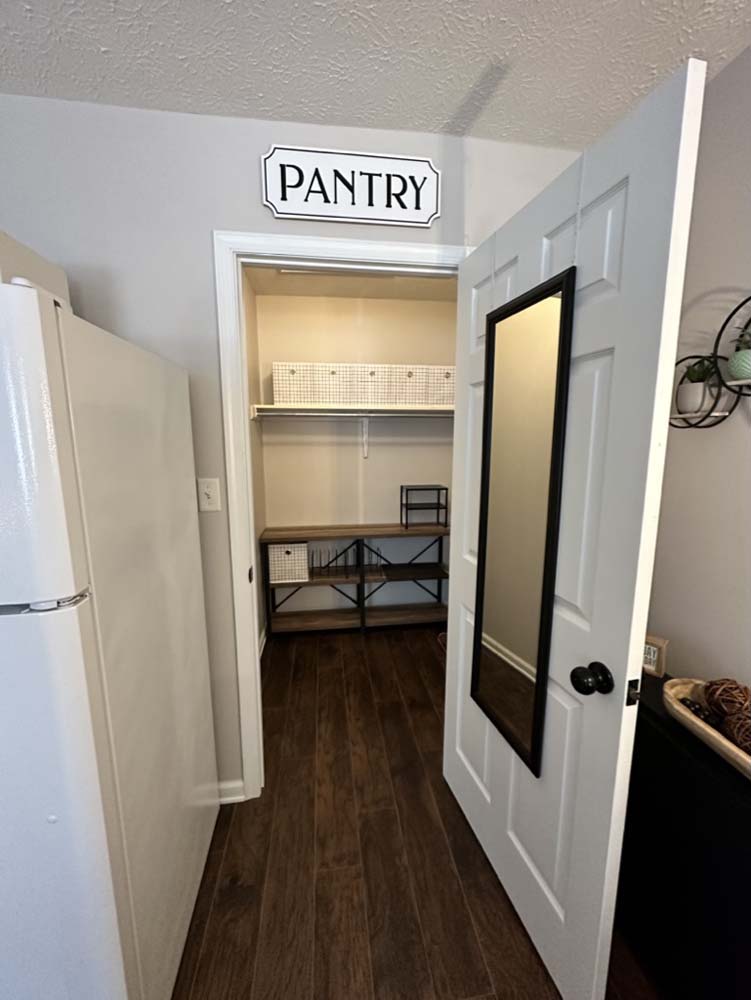 Walk-in pantry with shelving viewed from the kitchen