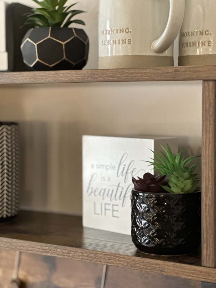Open shelf with Morning Sunshine mugs and decor