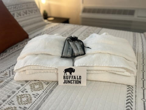 Welcome towel bundle with toiletries on the bed