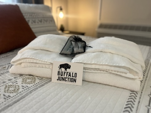 Close-up of welcome towels with Buffalo Junction logo card